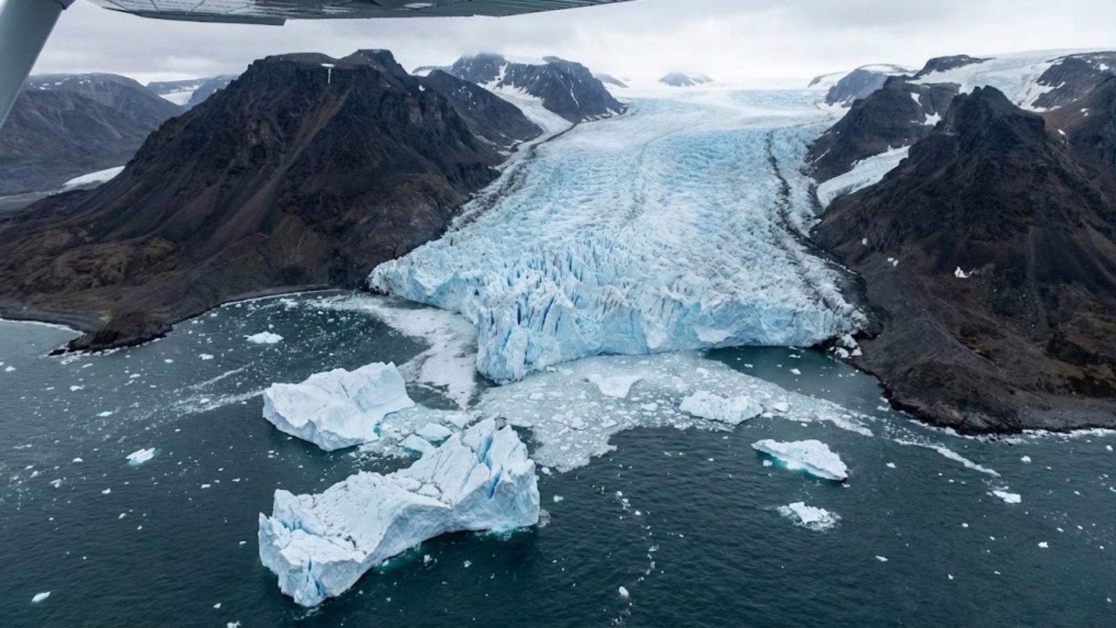 An outlet glacier breaking through a gap in the mountain ring